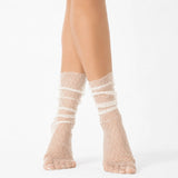 Ivory sheer designer ankle socks with delicate lace pattern styled on a female model against a light background