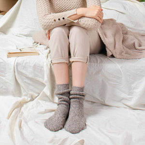 Person wearing light tan Norwegian wool socks