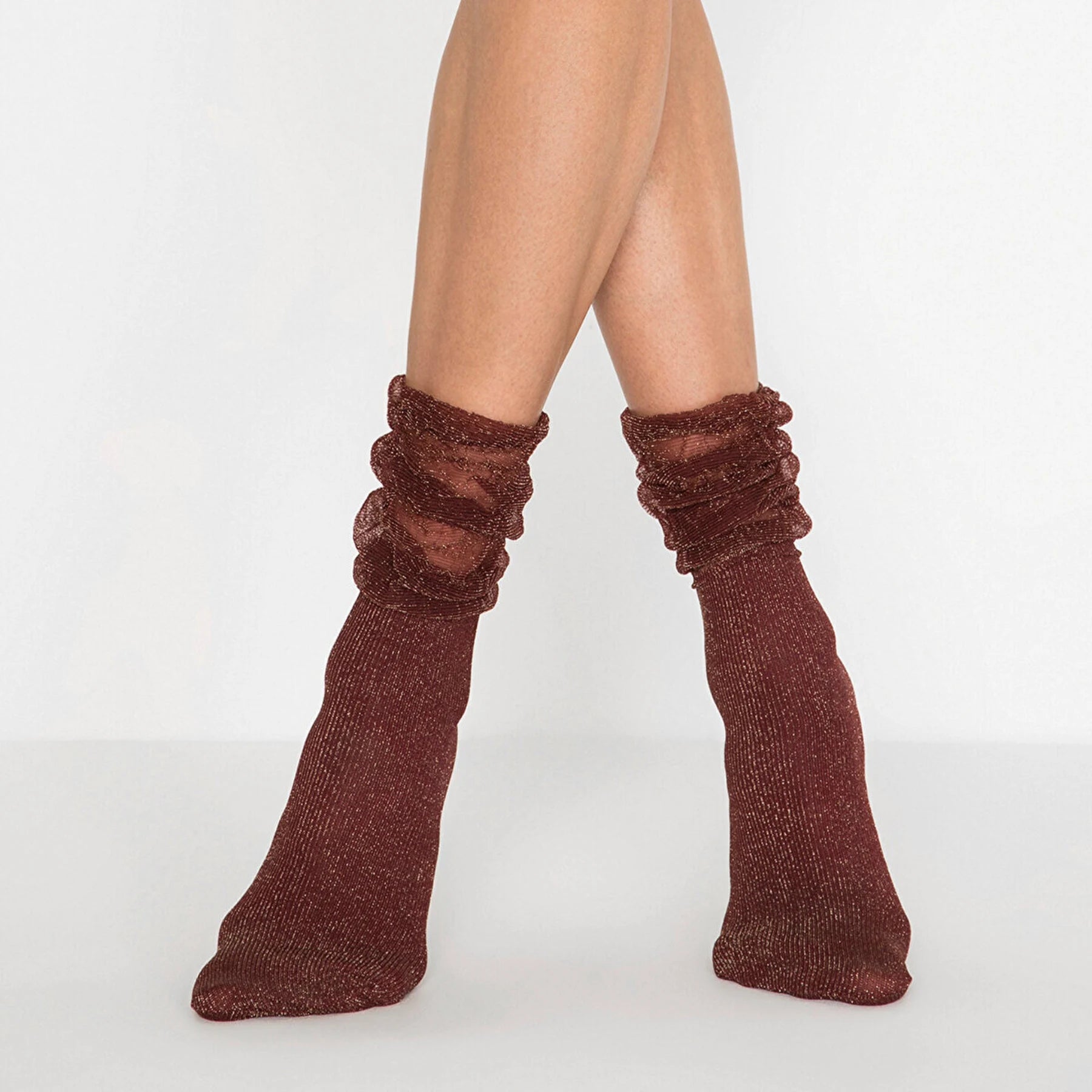 Image of woman's feet wearing burgundy and gold sparkled socks with loose fitting cuff