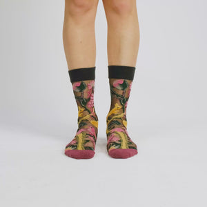 video of person wearing sheer socks with plant detail