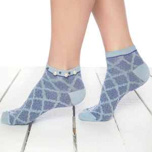 A woman wearing blue checked ankle socks embellished with pearls around the cuff