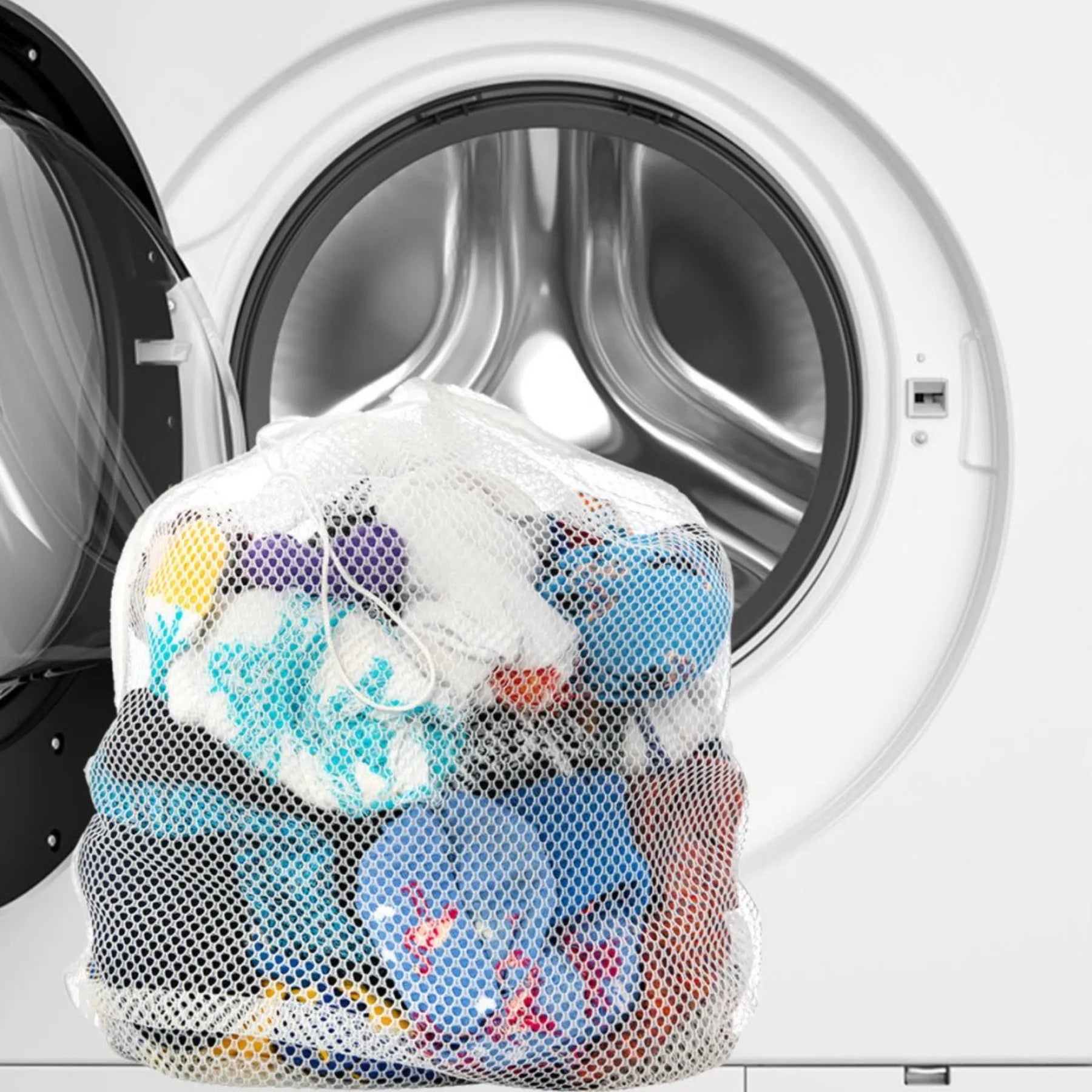 image of full laundry washing bag in front of washing machine