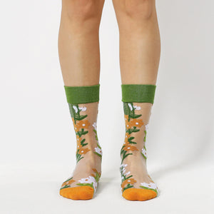 image of person wearing sheer socks with plant detail