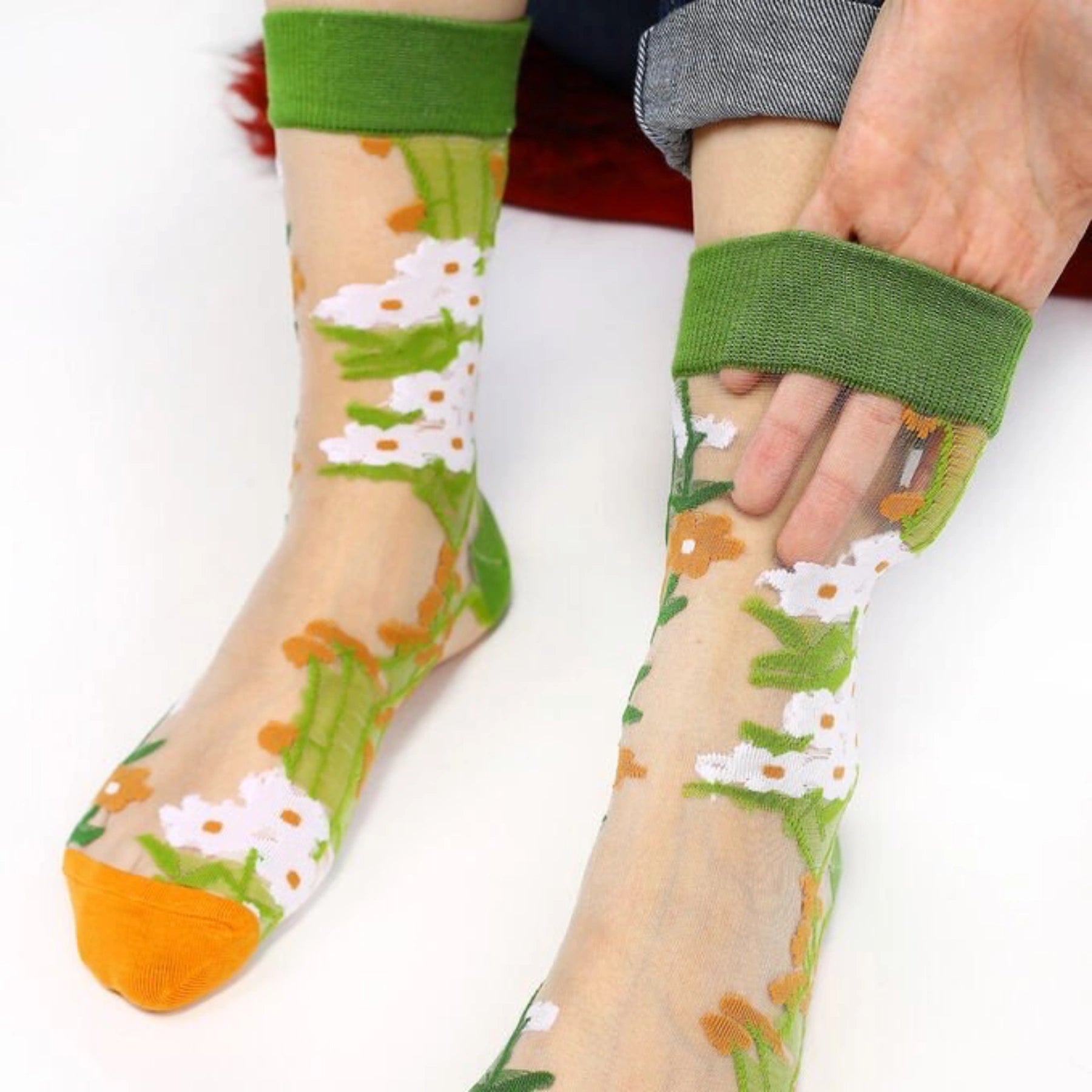 image of person wearing sheer socks with plant detail