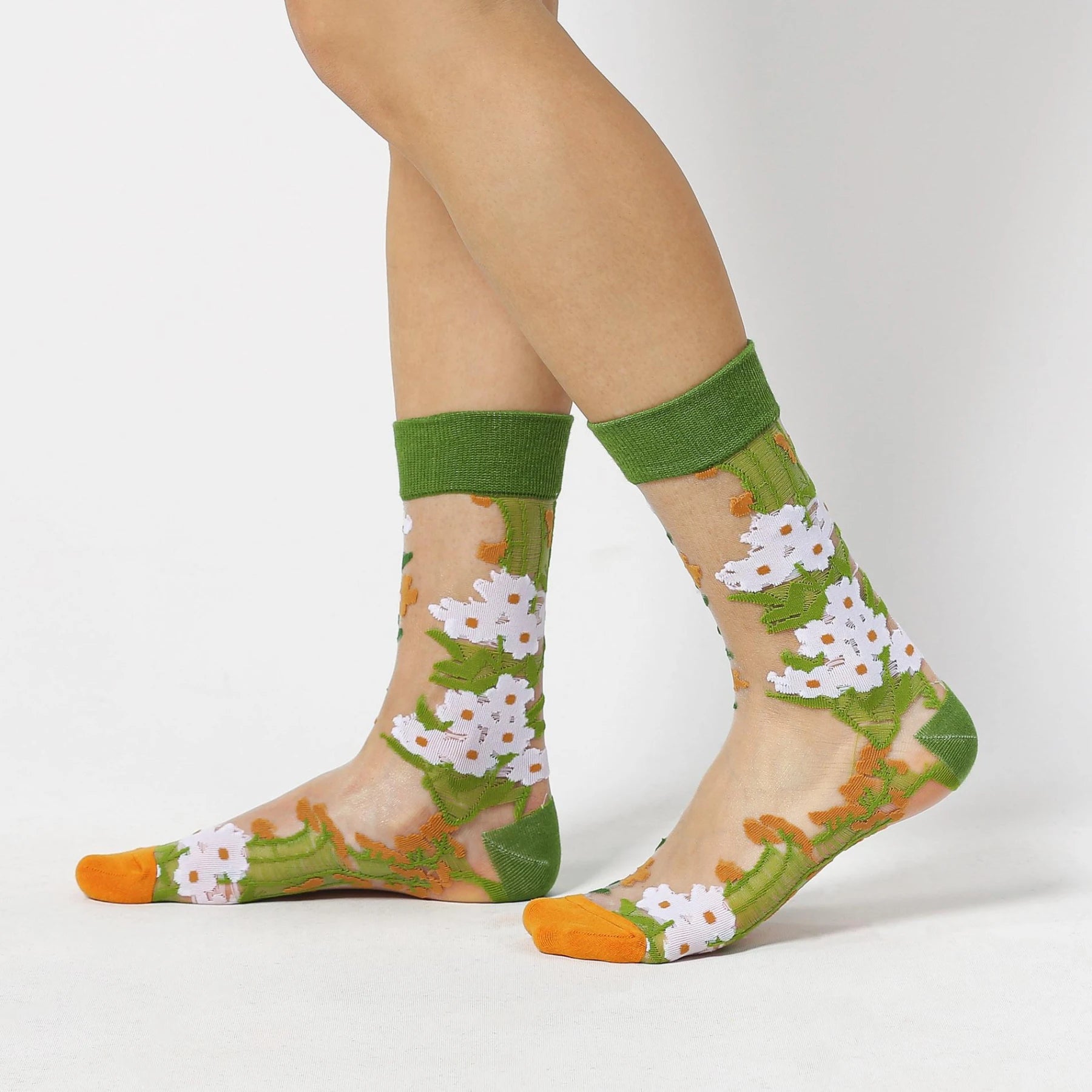 image of person wearing sheer socks with plant detail