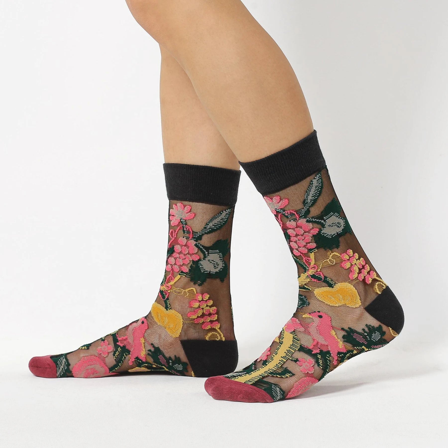 image of person wearing sheer socks with plant detail