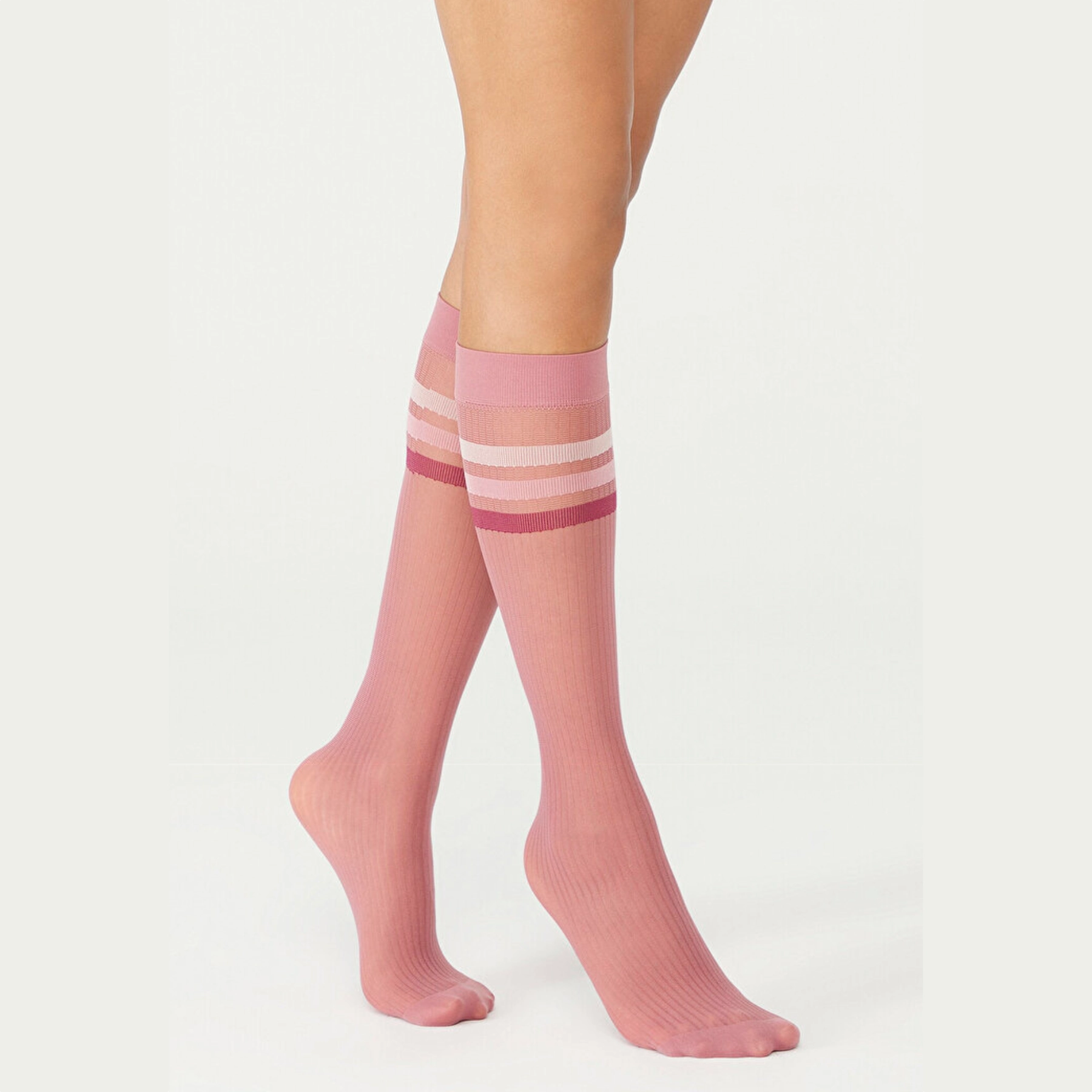 person wearing pink knee high socks with striped cuff