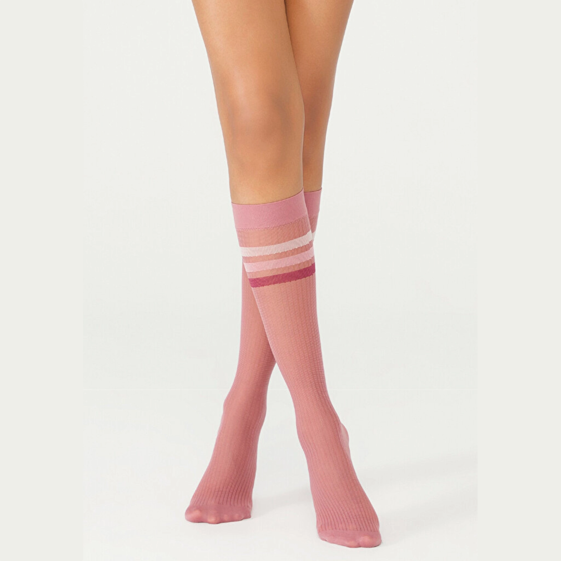 person wearing pink knee high socks with striped cuff