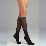 person wearing sheer black knee high socks with silver sparkly detail