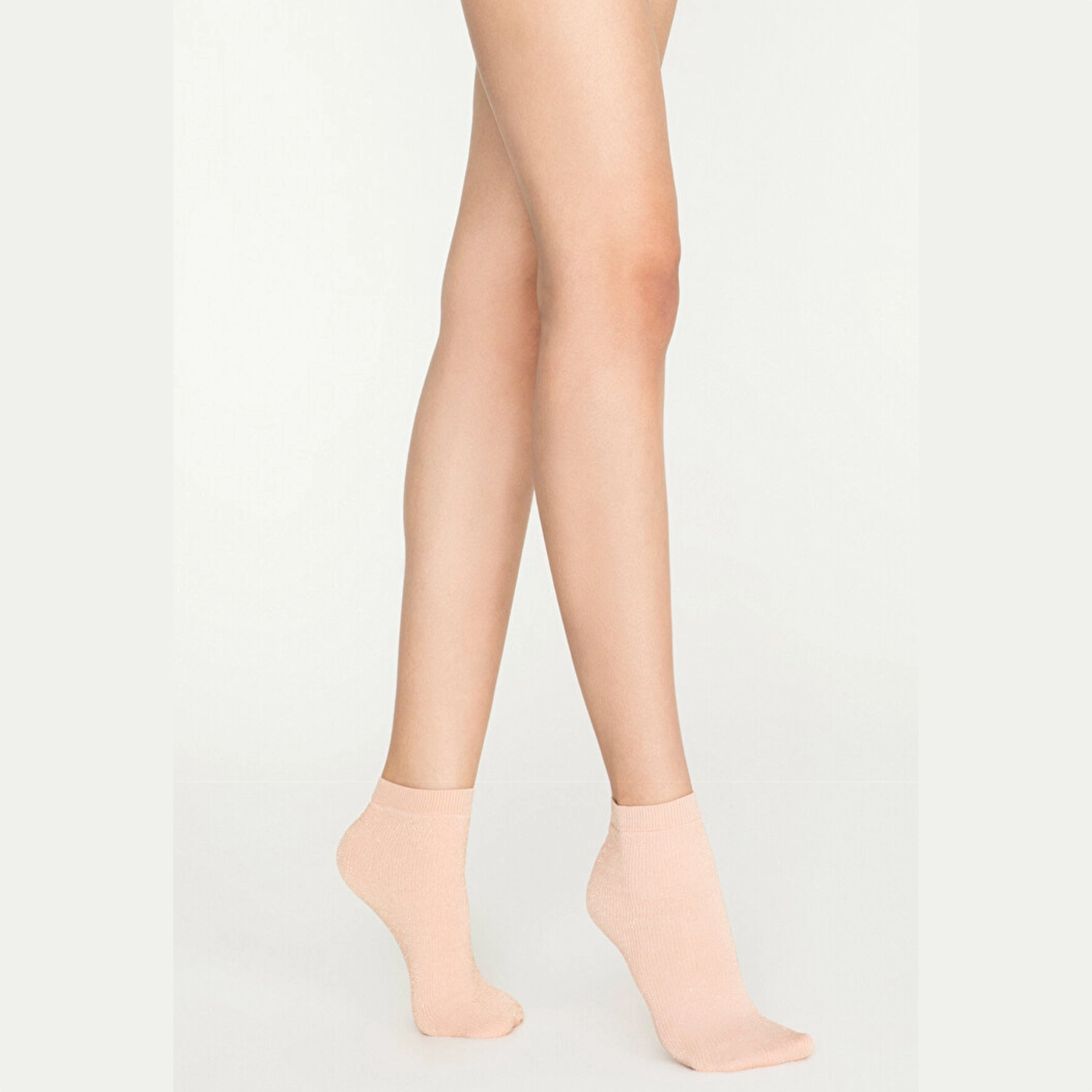 Woman wearing pink gold sparkle ankle socks