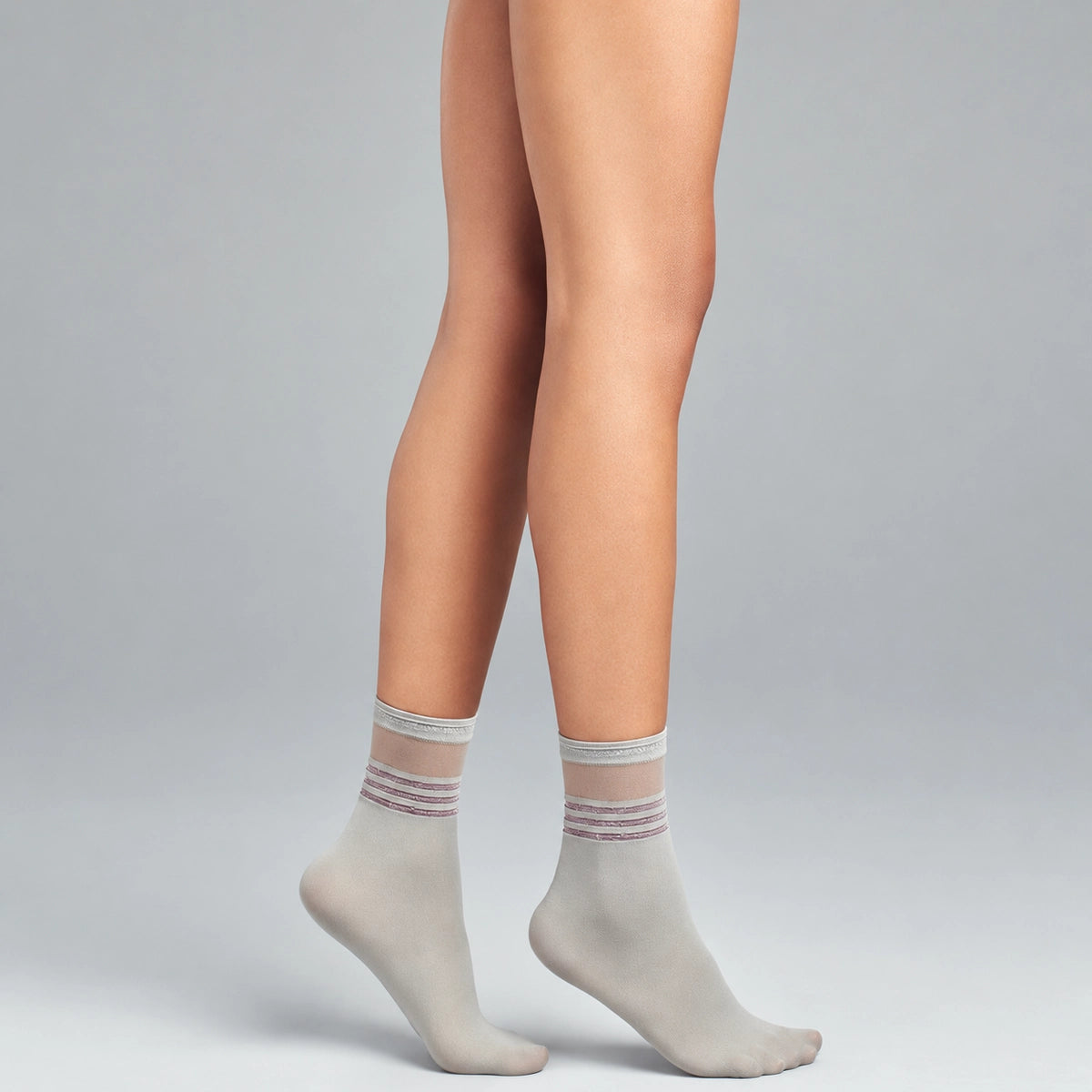 person wearing sheer grey quarter length socks with striped cuff
